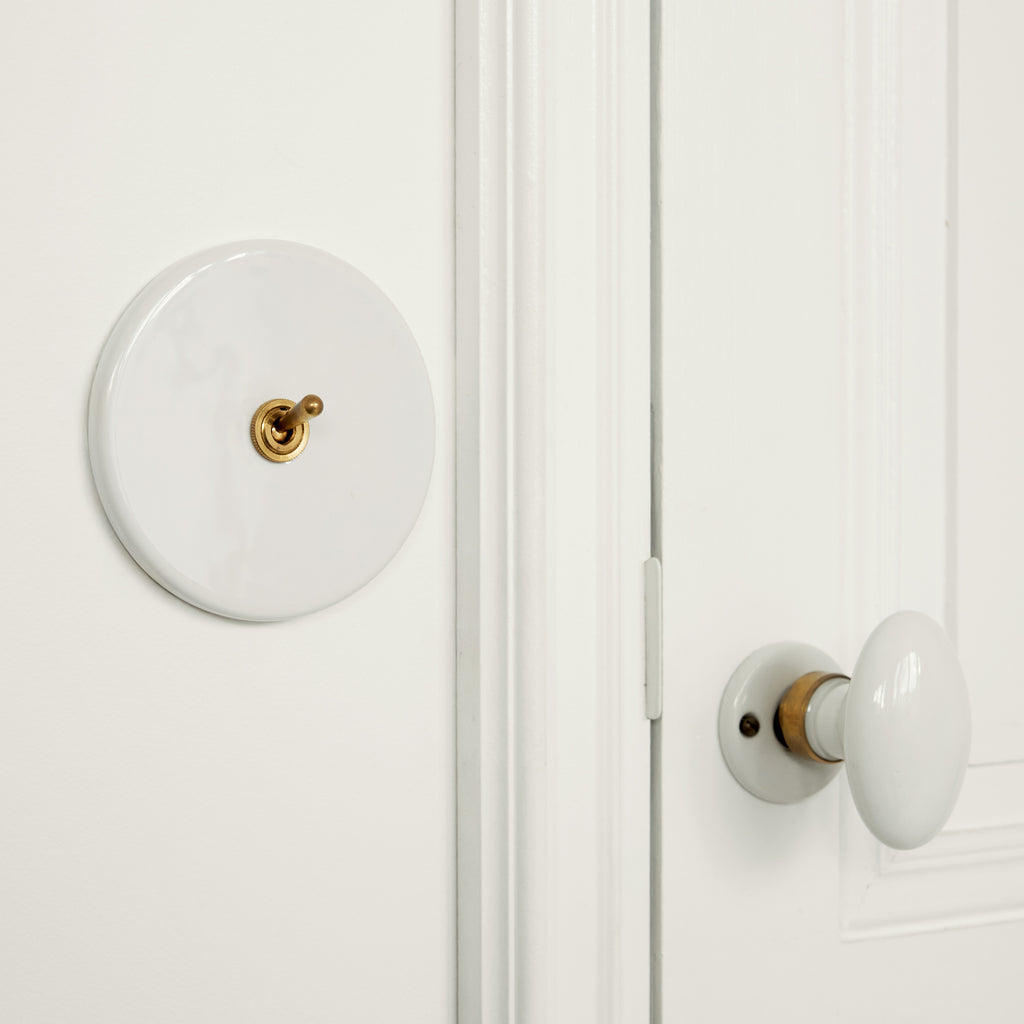Interrupteur blanc porcelaine et laiton