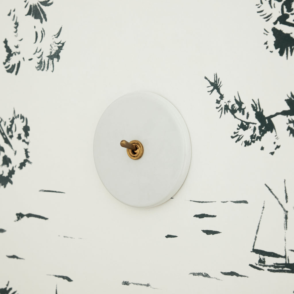 Interrupteur blanc porcelaine et laiton